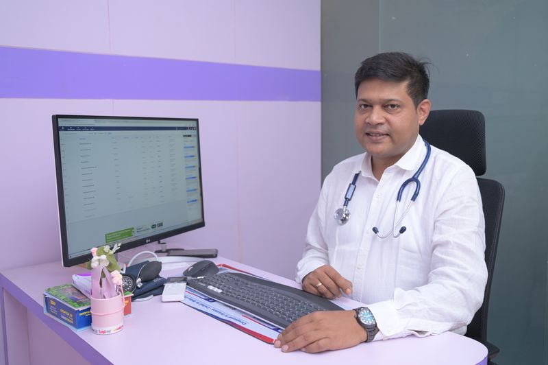 Dr Soumya Ghosh at the consultation desk with clinical records at Uttarbanga Clinic, Cooch Behar