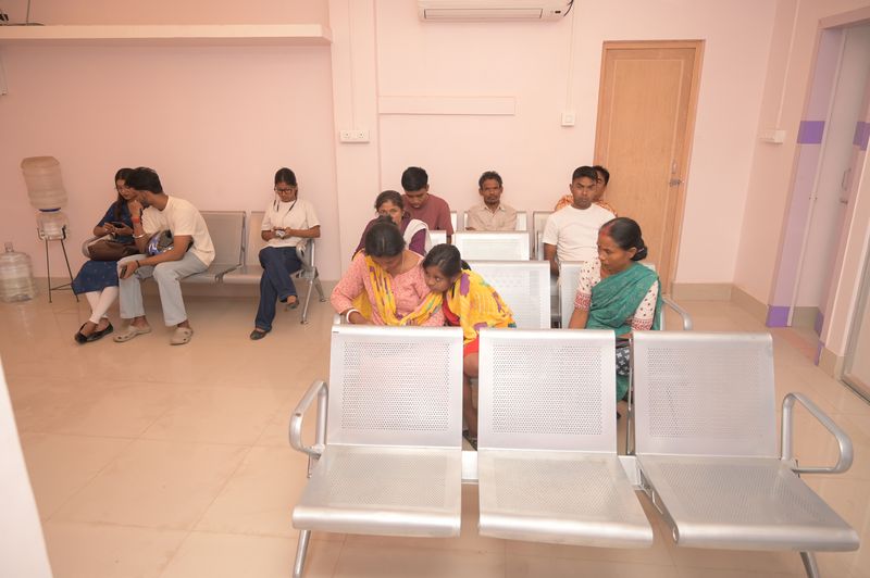 Patients waiting in the air-conditioned waiting hall at Uttarbanga Clinic, Cooch Behar
